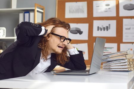male executive shows anguish looking at his laptop after a backup faiure