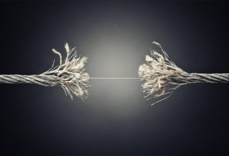 Picture shows a frayed rope under tension, held together by a single thread