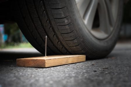 a car about to hit a nail gain a puncture