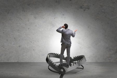 UK IoD paper looks at how business risks are expected to develop through 2025 Business person stood in an un-sprung bear trap