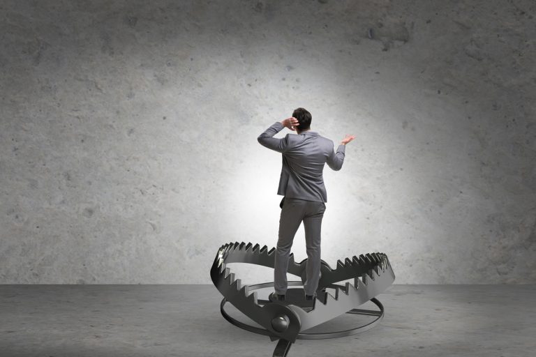 - Resilience Forward Business person stood in an un-sprung bear trap
