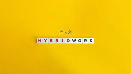 Graphic showing hybrid work words with an icon of an office and a house on a bright yellow background