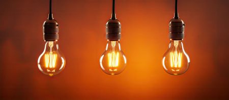 Three core aspects of resilient companies Three hanging light bulbs portray the concept of three core aspects of resilience.