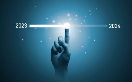 2024 risk and operational resilience predictions - a finger drags a slider from 2023 to 2024 in front of a technology concept background