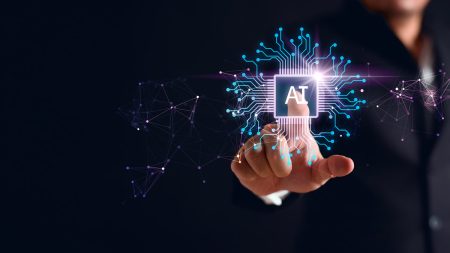 MAS announces generative AI risk framework for the financial sector Artificial intelligence concept - a hand pushes a chip-based button to launch AI