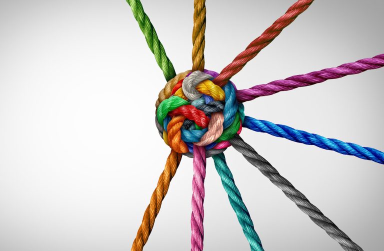 concept showing organizational resilience being stronger than its individual elements - various coloured pieces of rope converge and are knotted together in the centre.
