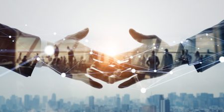 Concept image shows two people shaking hands while AI augments the transaction.