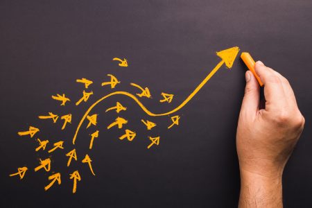The 9th Annual Global Risk and Resilience Trends Report A hand draws a trend arrow in yellow chalk.
