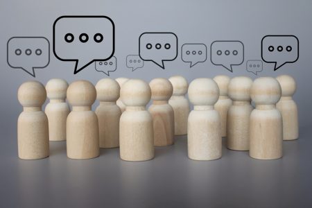 Discussion and dialogue concept; People figures with speech bubbles.