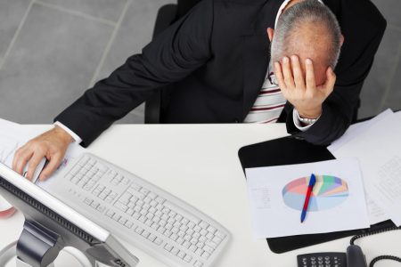 CTOs consider human error to be their biggest cyber security threat An employee holds his head in his hands after accidentally launching malware on his computer.