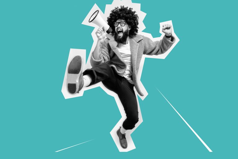 A person holding a megaphone enthusiastically makes an announcement.