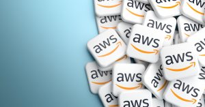 Logos of the Amazon cloud services AWS on a heap on a table.