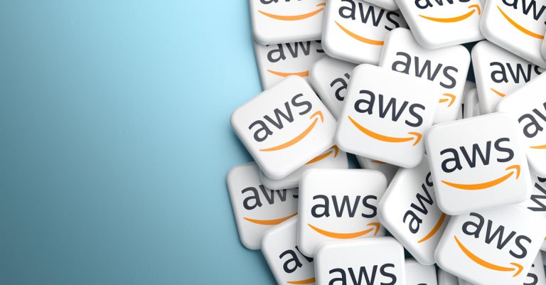 AWS - Resilience Forward Logos of the Amazon cloud services AWS on a heap on a table.