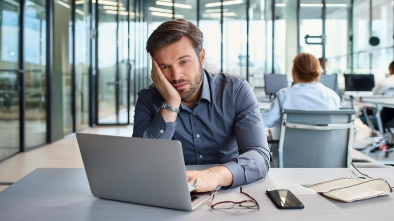 IT security training - Resilience Forward A bored employee watches unengaging IT security training.