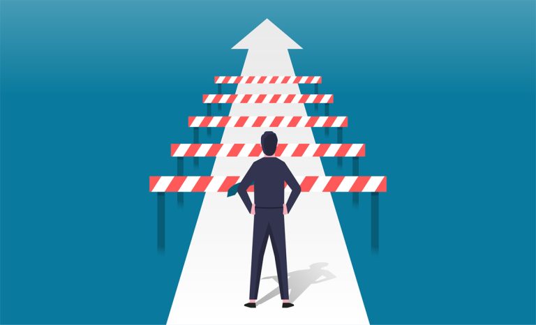 A person looks at a number of barriers in their way.