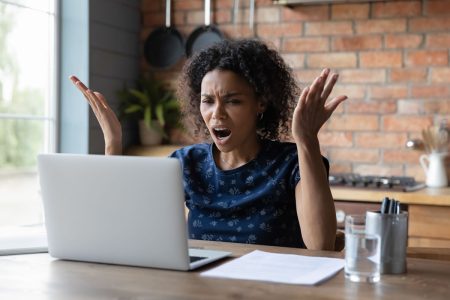 An annoyed person reacts to digital downtime.