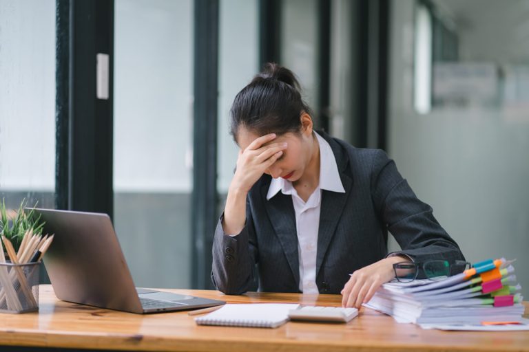 A business woman shows signs of severe stress during a difficult ransomware incident response