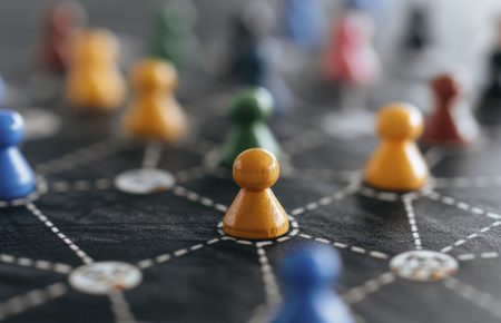 Interlinked chess pawns illustrate the concept of a holistic framework.