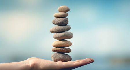 Trend Micro CEO Eva Chen calls for rebalancing of security and business continuity A hand holding stacks of rocks.