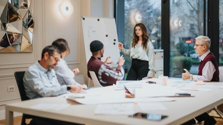 Focused team members in a light-flooded office during a business presentation.