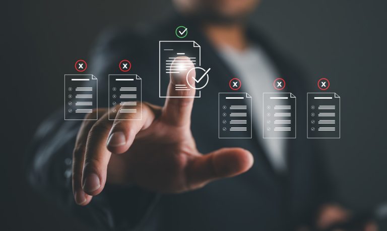A finger points to a document which the organization is compliant with.