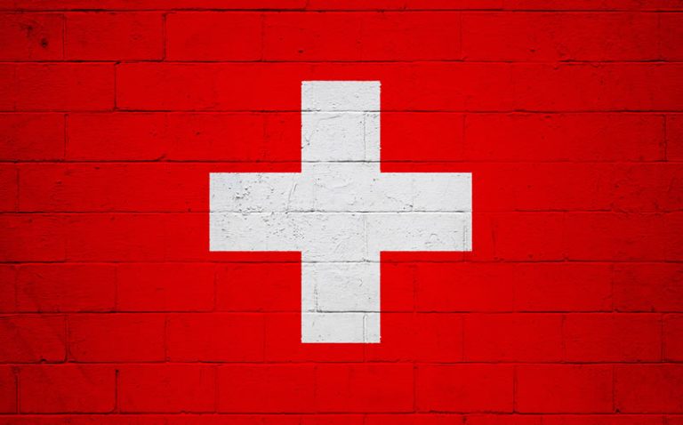 Swiss resilience - Resilience Forward A Swiss flag overlaid on a brick wall.