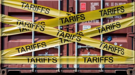 The emerging tariff war shows that resilience must include business risks Cargo Containers in a port with Yellow 'TARIFFS' Caution Tapes.