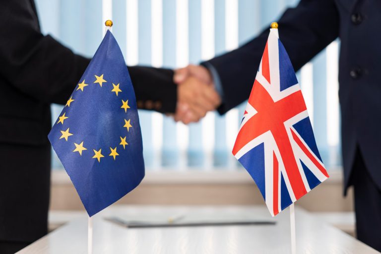 Political flags of European Union and United Kingdom on table. concept of negotiations, collaboration and cooperation of countries. agreement between governments.