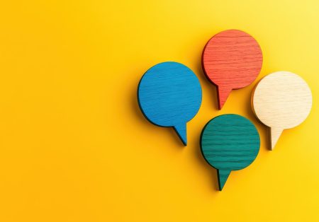Using business continuity awareness raising as a feedback loop Four speech bubbles on a bright yellow background.