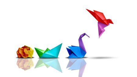 Change adoption is a crucial aspect of the capability to adapt: but the majority of organizations struggle with it A scrunched up ball of paper is folder into a boat, then a swan, then a bird - showing the concept of change.