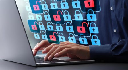 A laptop user with a variety of icons showing a mix of secure and vulnerable apps being used.