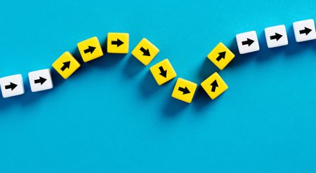 Resilience: the art and science of thriving in an uncertain world Flexibility and adaptation concept. Arrows on cubes following a flexible path.