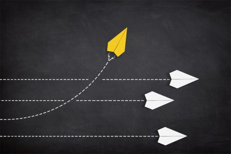 Long-running threat survey sees shift in how organizations perceive and prioritize resilience A yellow paper plane coming out from a line of white paper planes.