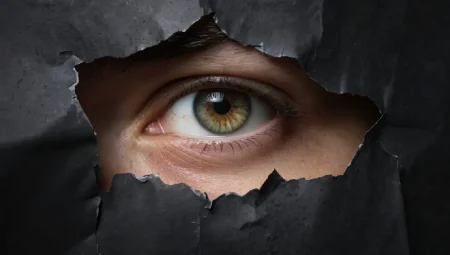 The critical GenAI blind spots that organizations need to address Close-up of human eye looking through torn paper.