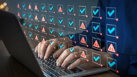 CSA issues Capabilities-Based Risk Assessment for AI systems Man using laptop for risk checklist with tick marks and error warnings.