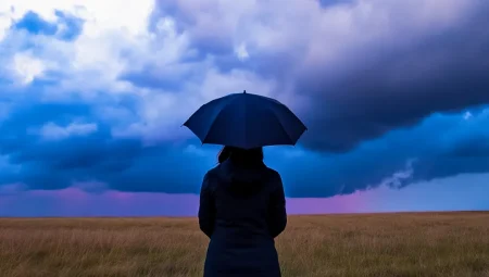 Risk Outlook report: uncertainty is shaping the pace of preparedness Person standing in a field holding an umbrella under dark clouds gathering.