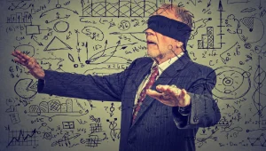 A blindfolded elderly senior business man unable to see his organization's data.