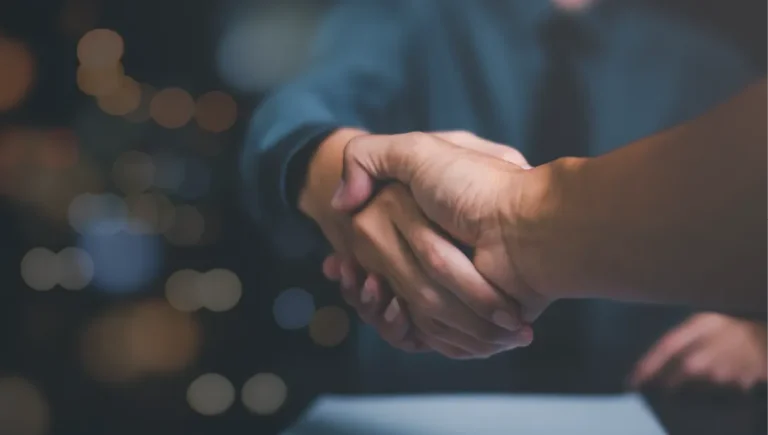 Close up of two hands shaking.