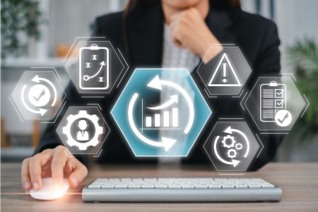 Business resilience research finds that most UK organizations have low maturity Business resilience concept - a business woman works behind a set of icons reflecting the various elements.