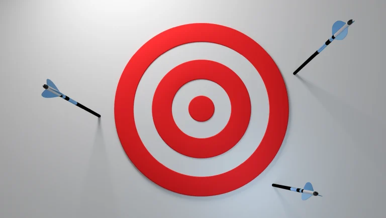 A target with three arrows around the outside of it.