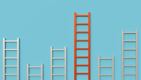 Multiple white ladders with varying heights against orange background - shows the concept of multiple capabilities.