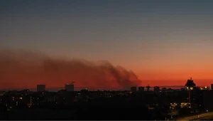 European wildfire - Resilience Forward Smoke from a fire over a night city: a sunset sky in Rome, Italy, with smoke drifting across.