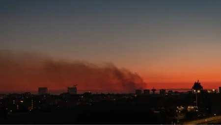 Smoke from a fire over a night city: a sunset sky in Rome, Italy, with smoke drifting across.